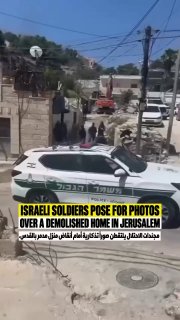 Footage documents Israeli occupation female soldiers taking smiling commemorative photos in front of the rubble of the B